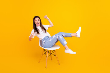 full size profile side photo of young woman happy smile sit chair rejoice victory fists hands isolat