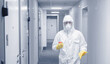 Disinfect worker in biohazard sanitize and clean home apartment vs infection virus, kill bacteria. Blue color toning