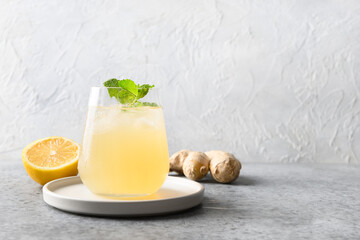 Healthy kombucha beverage in glass with lemon and ginger. Organic probiotic freshness drink for hot summer.