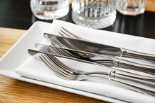 Serving With Forks And Knives On The Dining Table.