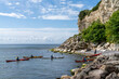 group of sea kayakers make a landing on a rocky beach on the coast of Denmark at Stevns Klint