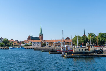 Poster - cityscape of the harbor and old town of Helsingor in northern Denmark with colorful fishing boats in the foreground