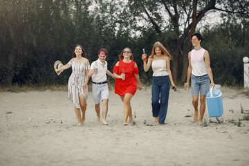 Friends have fun on a beach with drinks