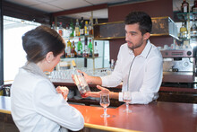 Barman Chatting With An Elegant Female Customer