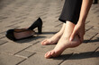 woman hand in ache leg and high shoes in street