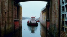 A Motor Boat Enters The Harbour On A Misty Day