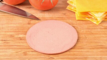 Poster - Slices of beef bologna vanishing from a cutting board, stop motion animation