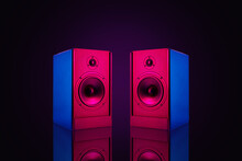Two Neon Colored Stereo Speakers On Dark Background With Reflection.Sound Audio Loud Speakers, Close Up
