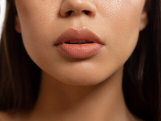 close-up of woman's lips with fashion natural beige lipstick makeup. macro sexy pale lipgloss make-u