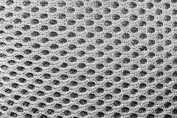 Close-up texture photo of grey colored spacer mesh material pattern.