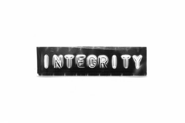 Sticker - Embossed letter with word integrity in black banner on white paper background