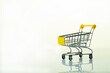 empty grocery cart on a light background with reflection