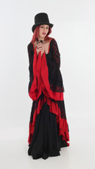 Sticker - full length portrait of red haired woman wearing long black gothic vampire gown. standing pose on white studio background