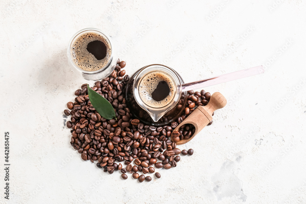 Pot and cup with delicious turkish coffee on light background