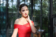 © FotoArtist - Young Asian Woman in a beautiful red dress looking at camera with smile. Fashion model, bride or pre-wedding concept.