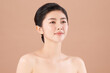 © kitthanes - Beautiful young asian woman with clean fresh skin on beige background, Face care, Facial treatment, Cosmetology, beauty and spa, Asian women portrait.
