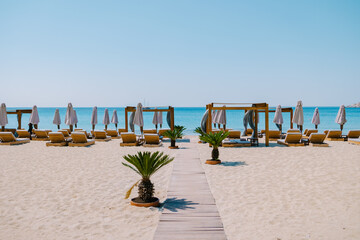 Wall Mural - Paralia Platis Gialos beach Mykonos, Petinos beach Mikonos island Greece, luxury beach bed chairs, and blue ocean. Mykonos Greece April 2018