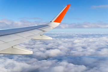 Wall Mural - wing airplane by airplane window frame, concept travel and freedom.