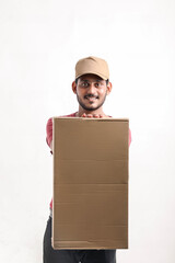 Happy Asian man in t-shirt and cap holding empty box isolated over white background, Delivery service concept