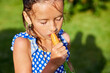 © bondarillia - A young girl holds and eat a carrot that she picked from her family's garden