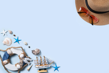 Wall Mural - Summer beach background design concept with shells, hat, sunglasses on blue background.