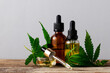 Cannabis oil in bottles on gray background with copy space.