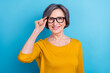 © deagreez - Portrait of attractive cheerful content woman touching specs healthy sight vision isolated over vivid blue color background
