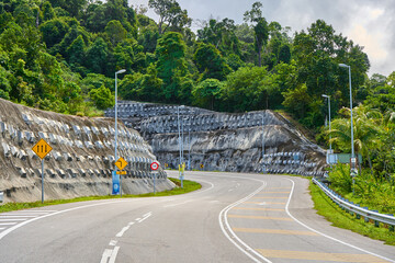 Wall Mural - Automobile road between stone rocks a a