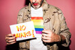 © ADDICTIVE STOCK - Crop homosexual male demonstrating paper with No Wars text