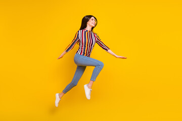 Wall Mural - Full size profile side photo of young woman happy positive smile jump up fly go walk run isolated over yellow color background