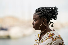 Thoughtful Black Woman With Ethnic Braids And Earrings Looking A