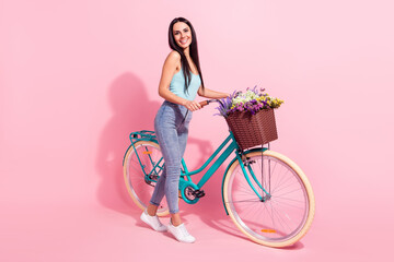 Sticker - Full length body size photo woman riding retro bike in summer with flowers isolated pastel pink color background