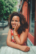© CarlosCalixto - black woman smiling chilling in a table