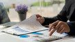 © ArLawKa - Business people work with graphs and laptop calculators to analyze the company's profitable costs with taxes and finance.
