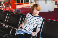 Woman Reading Newspaper At Charles De Gaulle Airport,