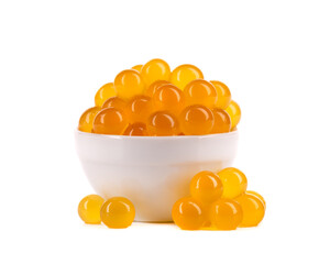 Yellow tapioca pearls for bubble tea isolated on white background. Tapioca pearls in white ceramic bowl.