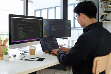 Young man programmer concentrate working on project in software development company.