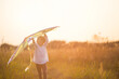 © Ольга Симонова - A girl runs into a field with a kite, learns to launch it. Outdoor entertainment in summer, nature and fresh air. Childhood, freedom and carelessness. A child with wings is a dream and a hope.