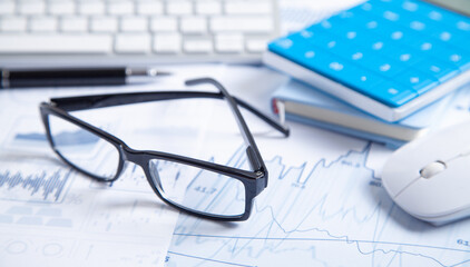 Business graphs, computer keyboard, pen, eyeglasses. Business. Analysis. Accounting