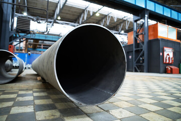 Fragment of a metallurgical plant with a large-diameter pipe in the foreground. Selective focus. Copy space