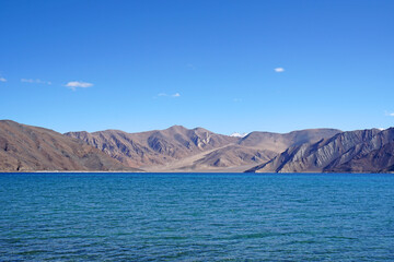 Landscape Lake Nature Scene of Pangong tso or Pangong Lake with Snow mountain background is best famous destination at Leh Ladakh ,Jammu and Kashmir , India - Blue nature travel  Background - travel