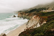 © ADDICTIVE STOCK - Misty rocky coast washing by troubled ocean waves in overcast weather