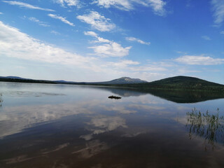 Wall Mural - mountains and the sky are reflected in a lake