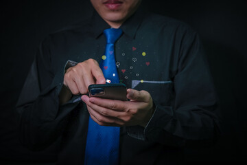 Wall Mural - businessman in a black suit communicates with a virtual digital phone screen online.