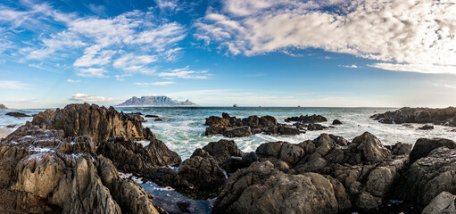 Scenic vista of Table Mountain, Cape Town, South Africa. A stunning view from Table View - across the bay where tourists and surfers alike come to enjoy the beach and ocean.