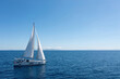 © Rawf8 - Sailing boat with open white sails, blue sky and rippled sea background