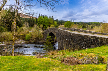 a view from the village beside the bridge of orchy near to glencoe, scotland on a summers day