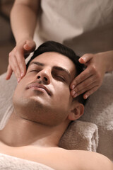 Wall Mural - Man receiving facial massage in beauty salon