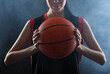 © New Africa - Basketball player with ball on black background, closeup