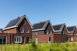 Solar panels on the roof of new built houses in The Netherlands collecting green energy from the sun in a modern and sustainable way. New technology on Dutch houses concept